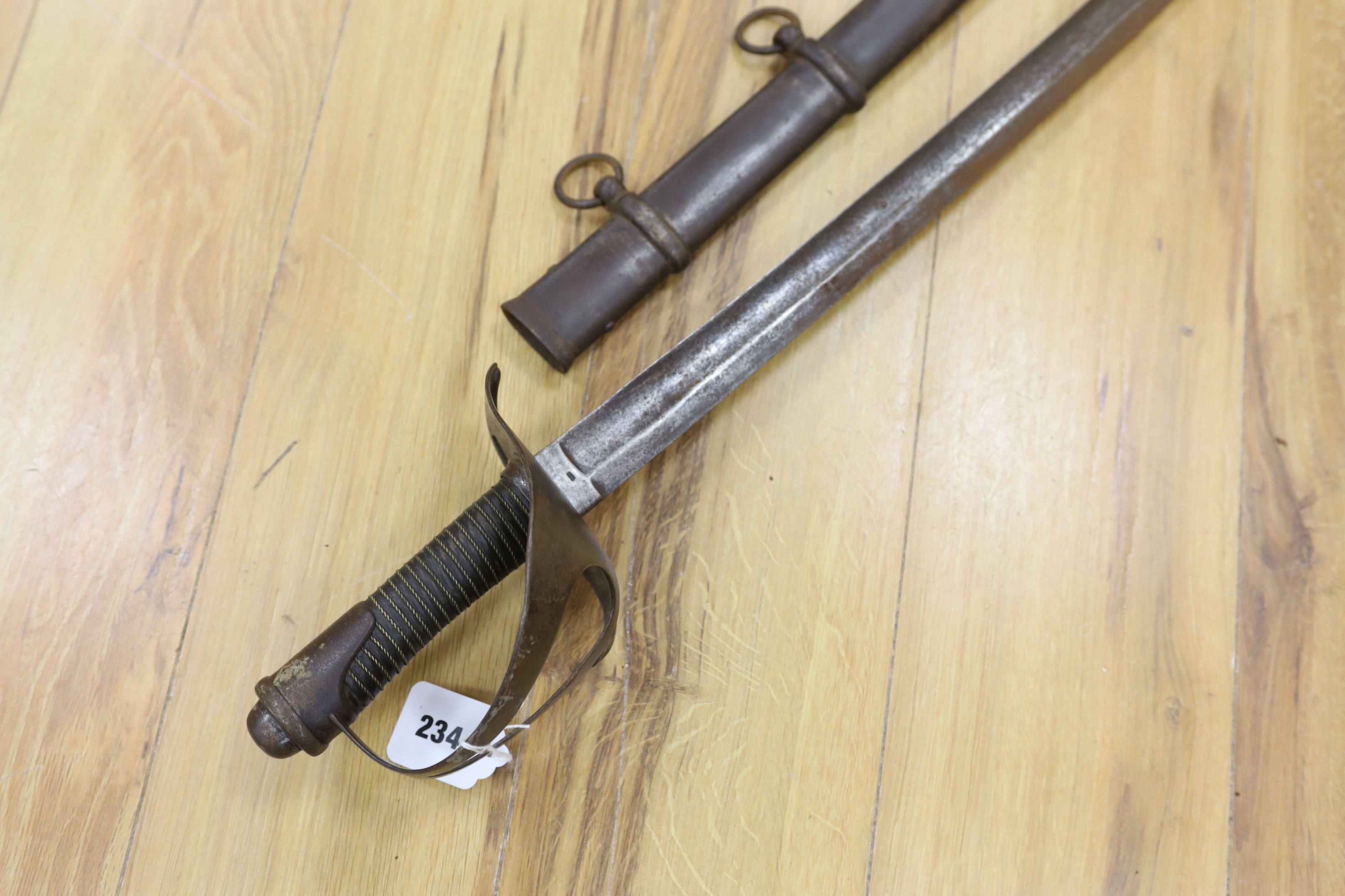 A pair of late 19th century German swords, one in its scabbard, together with another unrelated scabbard, made for the international arms trade, probably in Solingen, blade 89cm. Condition - fair, scabbards are 87cm and